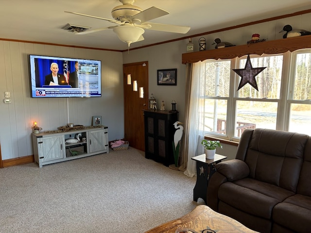 living room featuring crown molding, carpet flooring, and ceiling fan