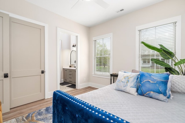 2 Moon Ct, Cape Charles, VA 23310 - bedroom featuring wood finished floors, connected bathroom, ceiling fan, and baseboards