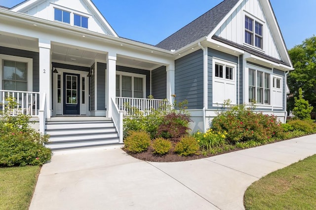 2 Moon Ct, Cape Charles, VA 23310 - view of exterior entry with board and batten siding, roof with shingles, and a porch