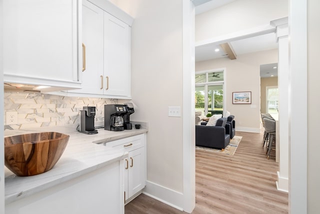 2 Moon Ct, Cape Charles, VA 23310 - bar area with tasteful backsplash, beam ceiling, baseboards, and light wood finished floors