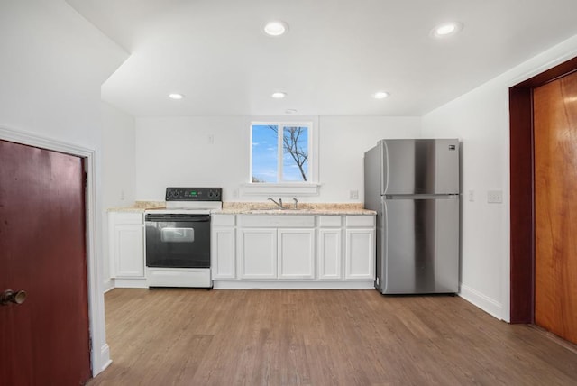 kitchen featuring light hardwood / wood-style floors, white cabinets, stainless steel refrigerator, and electric stove