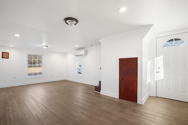 interior space featuring an AC wall unit and dark wood-type flooring