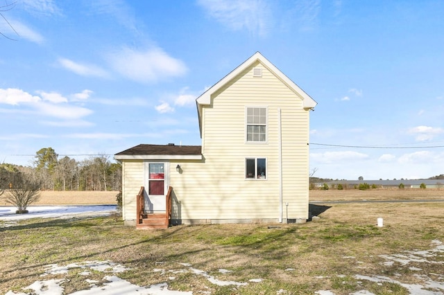 back of property featuring a yard