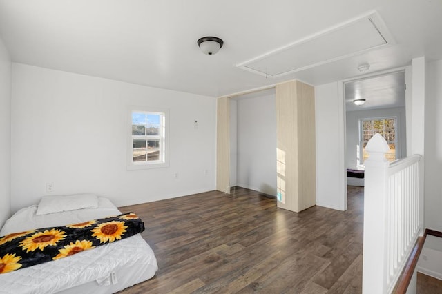 bedroom with dark hardwood / wood-style flooring