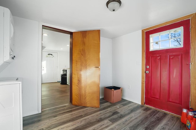 entrance foyer with stacked washer / drying machine and dark hardwood / wood-style floors