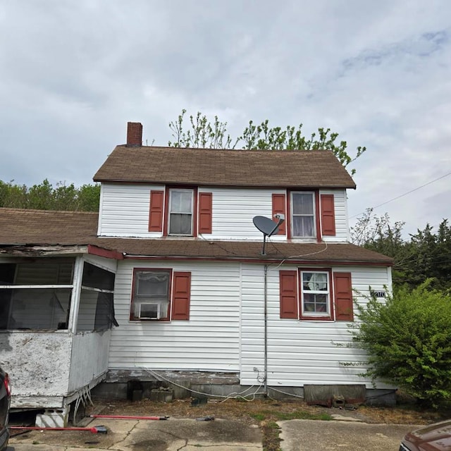 22170 Raymond Ln, Cape Charles, VA 23310 - view of side of property featuring roof with shingles, a chimney, and cooling unit