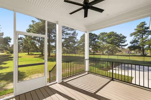 unfurnished sunroom with ceiling fan