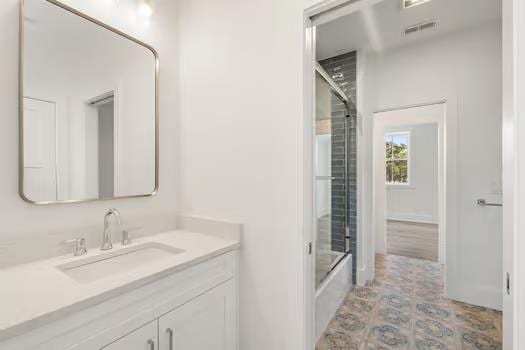 bathroom featuring vanity and enclosed tub / shower combo