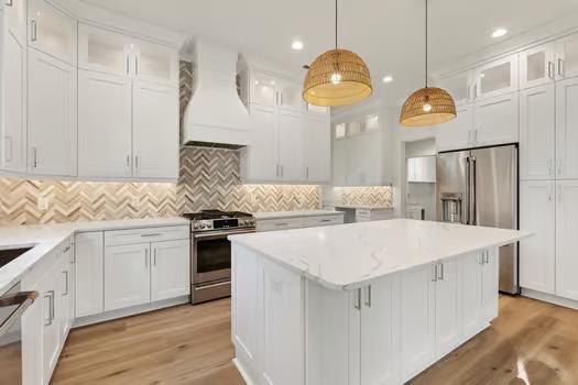 kitchen with pendant lighting, stainless steel appliances, white cabinetry, and custom exhaust hood