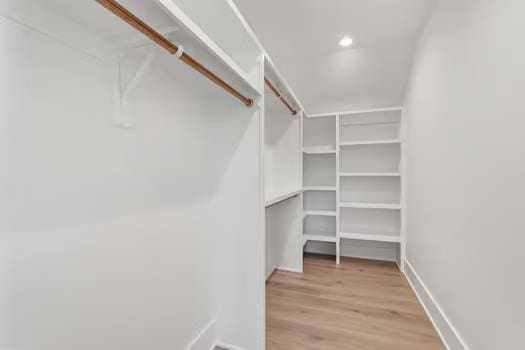 spacious closet with light hardwood / wood-style flooring