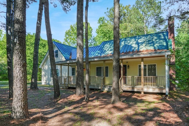 3315 Seaside Rd, Exmore, VA 23350 - view of front of house featuring a standing seam roof, covered porch, a chimney, and metal roof