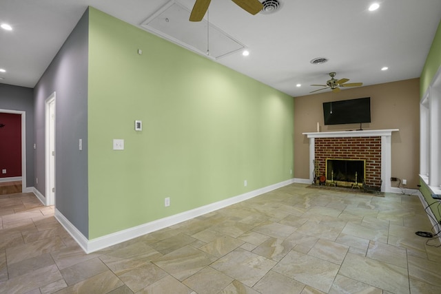 3315 Seaside Rd, Exmore, VA 23350 - unfurnished living room with attic access, ceiling fan, stone tile floors, a brick fireplace, and recessed lighting