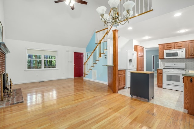 3315 Seaside Rd, Exmore, VA 23350 - kitchen featuring white appliances, light wood-style floors, light countertops, high vaulted ceiling, and ceiling fan