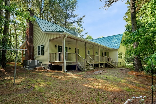 3315 Seaside Rd, Exmore, VA 23350 - rear view of property with a chimney, a standing seam roof, metal roof, central AC unit, and stairs