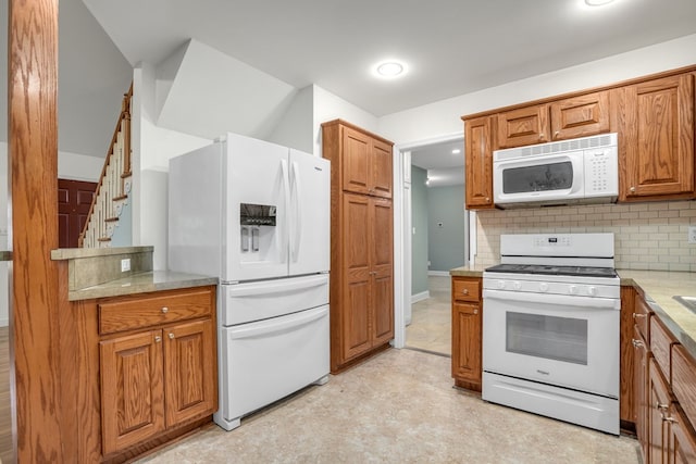 3315 Seaside Rd, Exmore, VA 23350 - kitchen featuring white appliances, brown cabinetry, backsplash, light floors, and recessed lighting