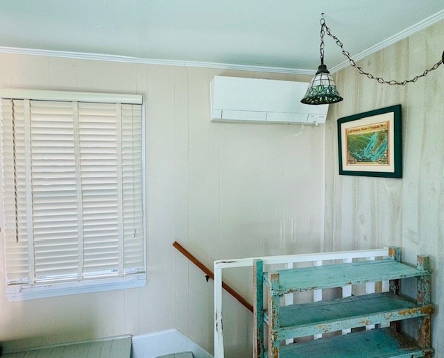 stairs with an AC wall unit and ornamental molding