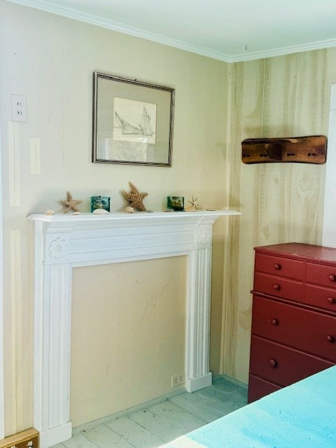 bedroom featuring wooden walls and crown molding