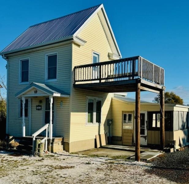 rear view of house featuring a patio area and a balcony