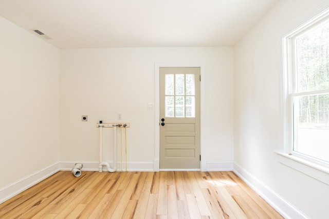 24455 Guilford Rd, Bloxom, VA 23308 - laundry area featuring electric dryer hookup, light wood-style floors, and healthy amount of natural light