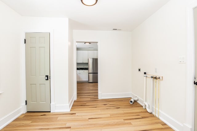 24455 Guilford Rd, Bloxom, VA 23308 - empty room featuring light wood-style flooring and baseboards
