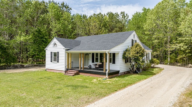 24455 Guilford Rd, Bloxom, VA 23308 - view of front of property with covered porch, roof with shingles, a front yard, driveway, and a view of trees