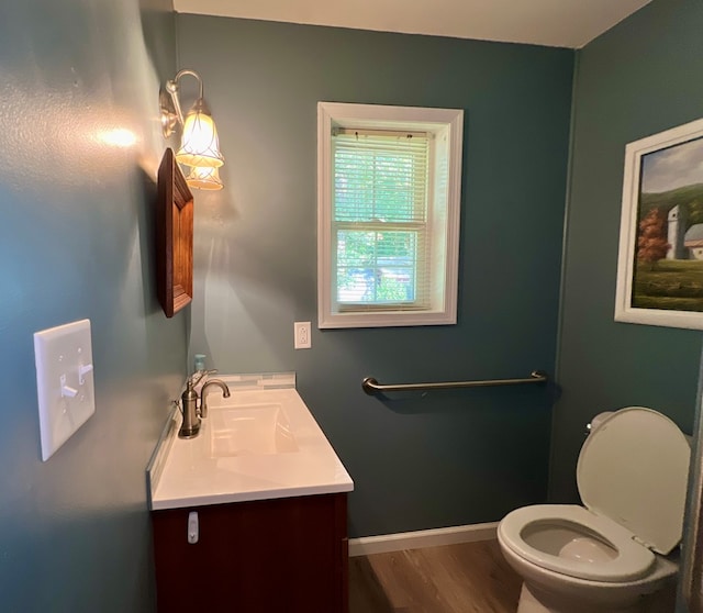 bathroom featuring hardwood / wood-style floors, vanity, and toilet