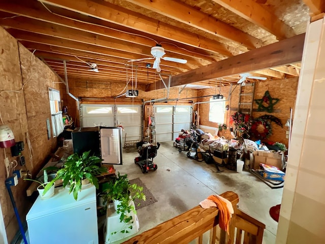 garage with a garage door opener and ceiling fan