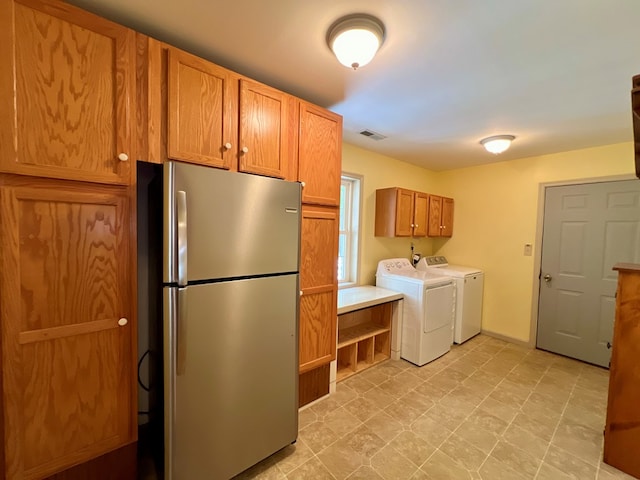 washroom featuring cabinets and independent washer and dryer