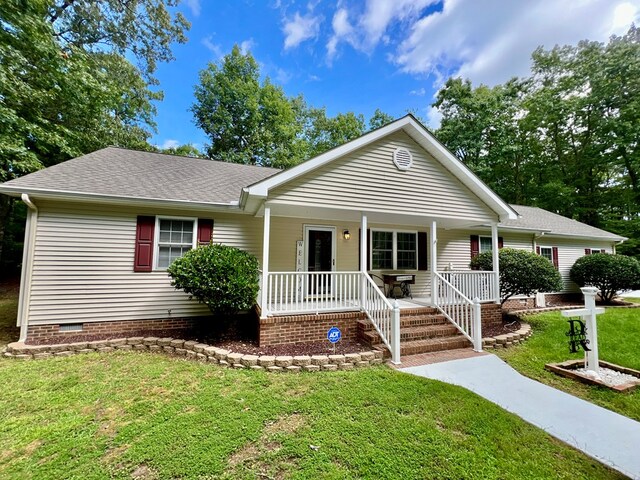 single story home with a porch and a front yard