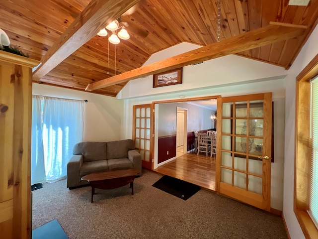 carpeted living room with french doors, vaulted ceiling with beams, ceiling fan, and wood ceiling