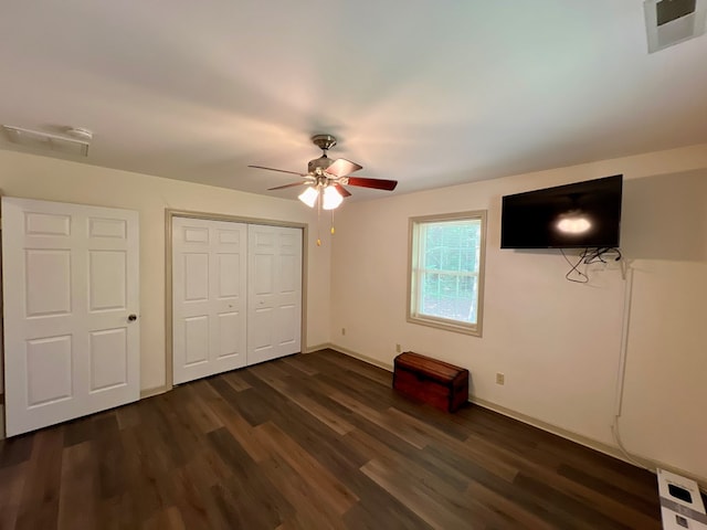 unfurnished bedroom with dark hardwood / wood-style floors and ceiling fan