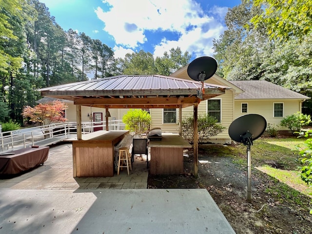 view of patio featuring a grill and an outdoor bar