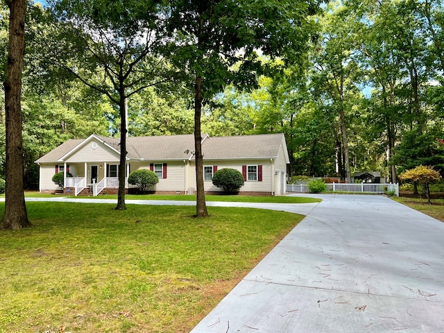 ranch-style home with covered porch and a front lawn