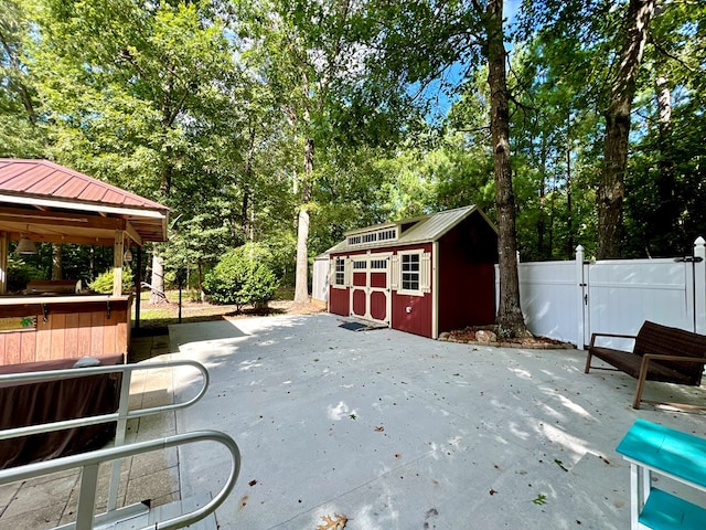 view of patio / terrace with a gazebo and a storage shed