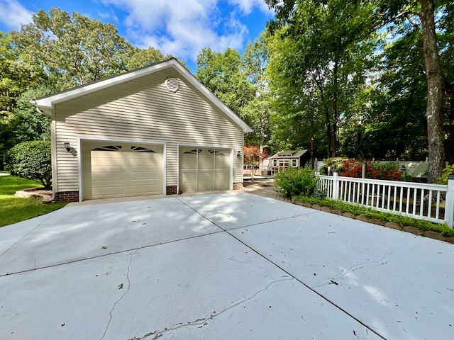 view of side of property featuring a garage and an outdoor structure