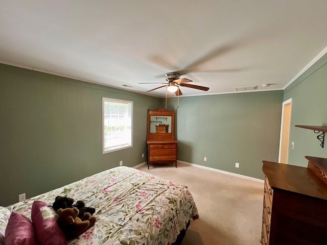 bedroom featuring ceiling fan, carpet floors, and ornamental molding