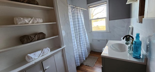 10117 Pine Ave, Nassawadox, VA 23413 - full bath with curtained shower, tile walls, wood finished floors, and vanity