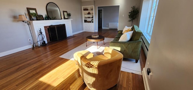 10117 Pine Ave, Nassawadox, VA 23413 - living area featuring a fireplace, wood finished floors, built in features, and baseboards