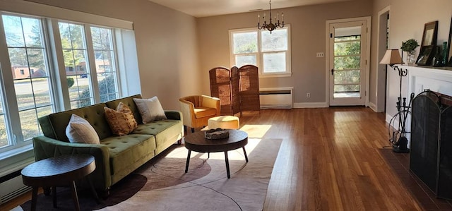 10117 Pine Ave, Nassawadox, VA 23413 - living area with a chandelier, a fireplace, baseboards, and wood finished floors