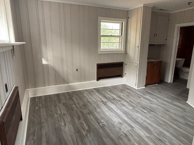 10117 Pine Ave, Nassawadox, VA 23413 - empty room featuring ornamental molding, radiator heating unit, wood finished floors, and baseboards