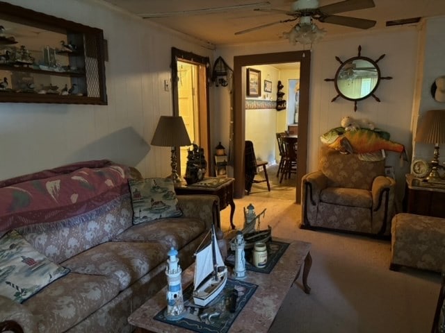 living room featuring ceiling fan and carpet