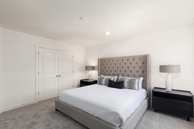 bedroom with light colored carpet and a closet