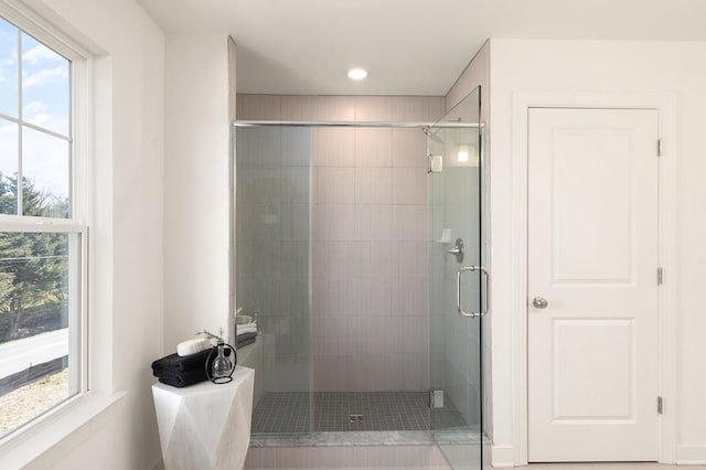 bathroom with an enclosed shower and a wealth of natural light