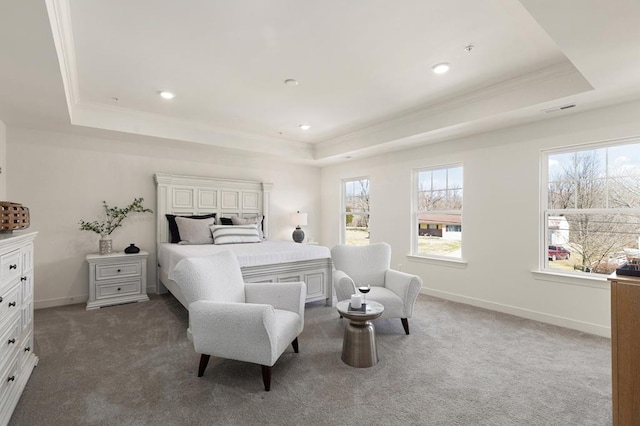 bedroom featuring a raised ceiling, crown molding, and dark colored carpet