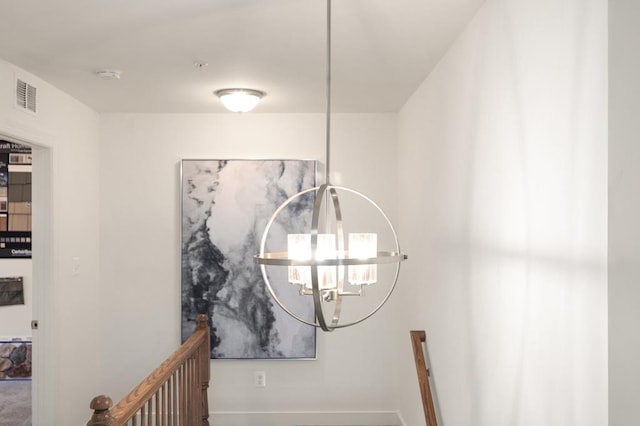 interior details featuring an inviting chandelier