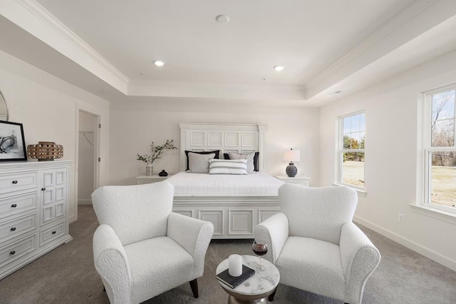 bedroom featuring a tray ceiling, dark carpet, and ornamental molding