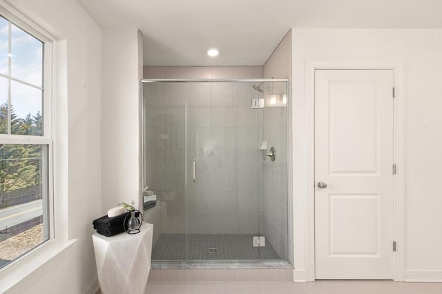 bathroom with tile patterned floors and walk in shower