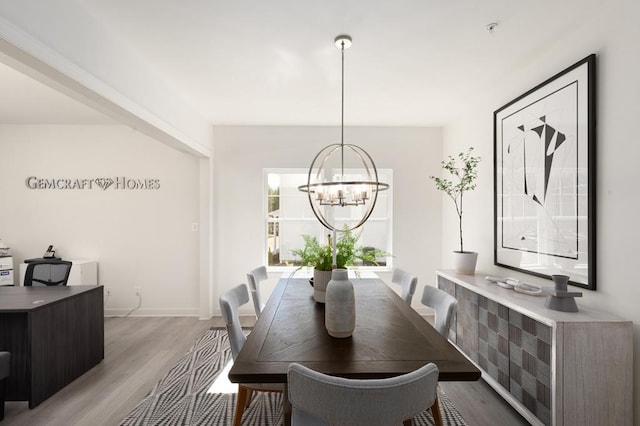 dining room featuring light hardwood / wood-style flooring and an inviting chandelier