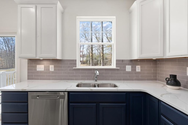 kitchen featuring white cabinets, light stone counters, blue cabinets, sink, and dishwasher