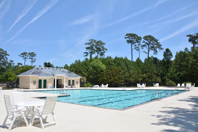 view of tennis court featuring basketball hoop